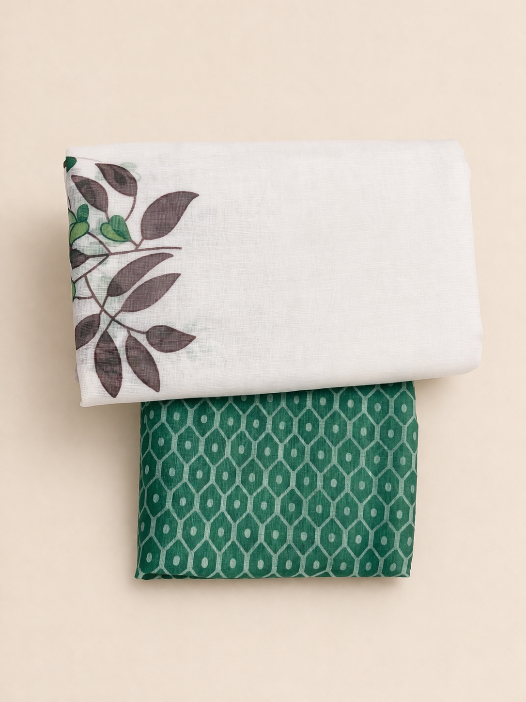 Two folded fabrics with leaf and geometric patterns on a beige background