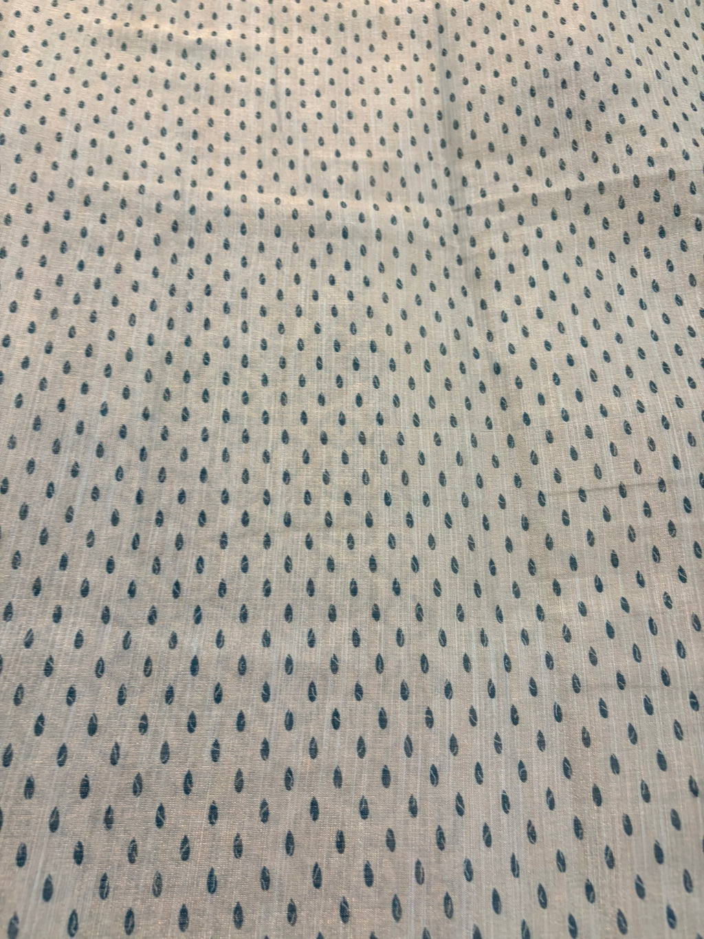 Textured fabric with a subtle pattern on a beige background