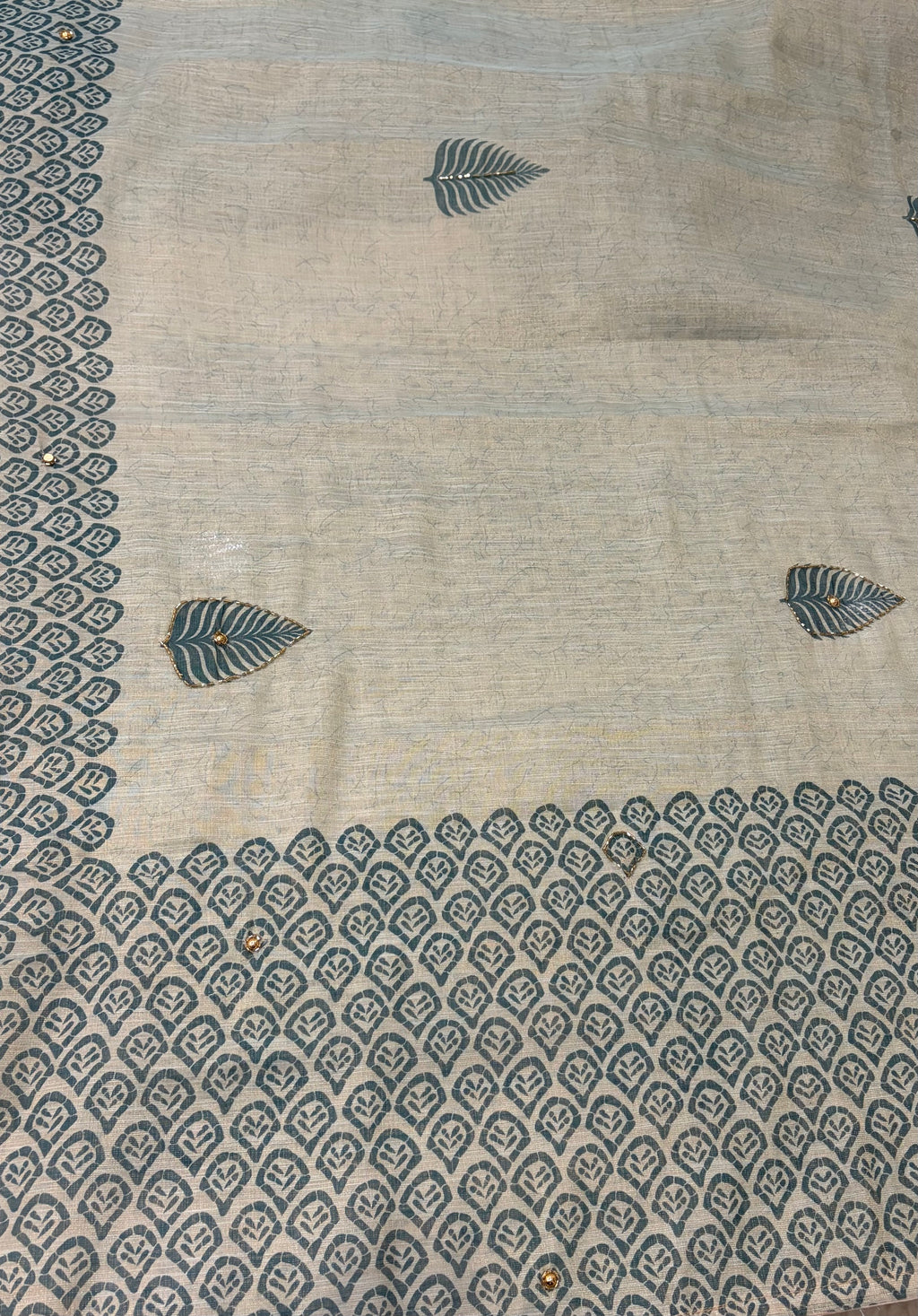 Beige fabric with blue leaf and diamond pattern